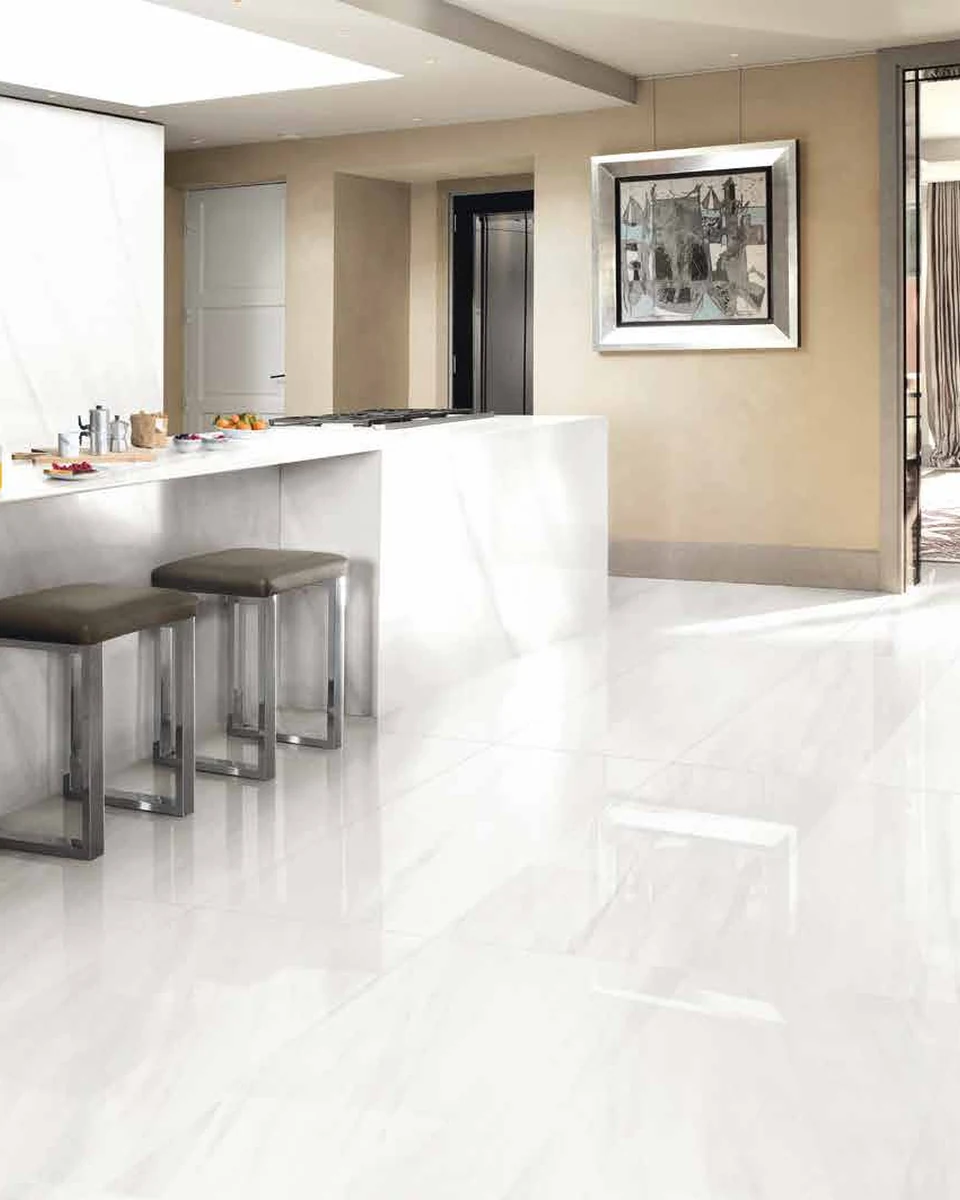 Porcelain tile running across a floor and up a wall in a finished interior